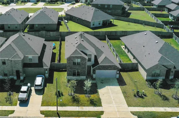 an aerial view of residential houses with outdoor space and swimming pool