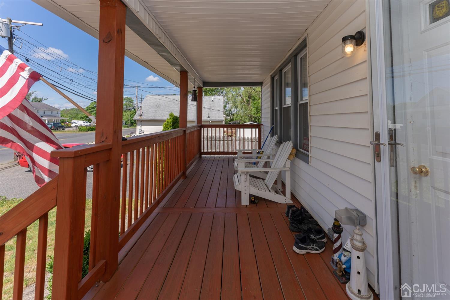 109 Stone Road Union Beach, NJ 07735 - Photo 2 of 21 a view of a balcony with chairs and wooden floor