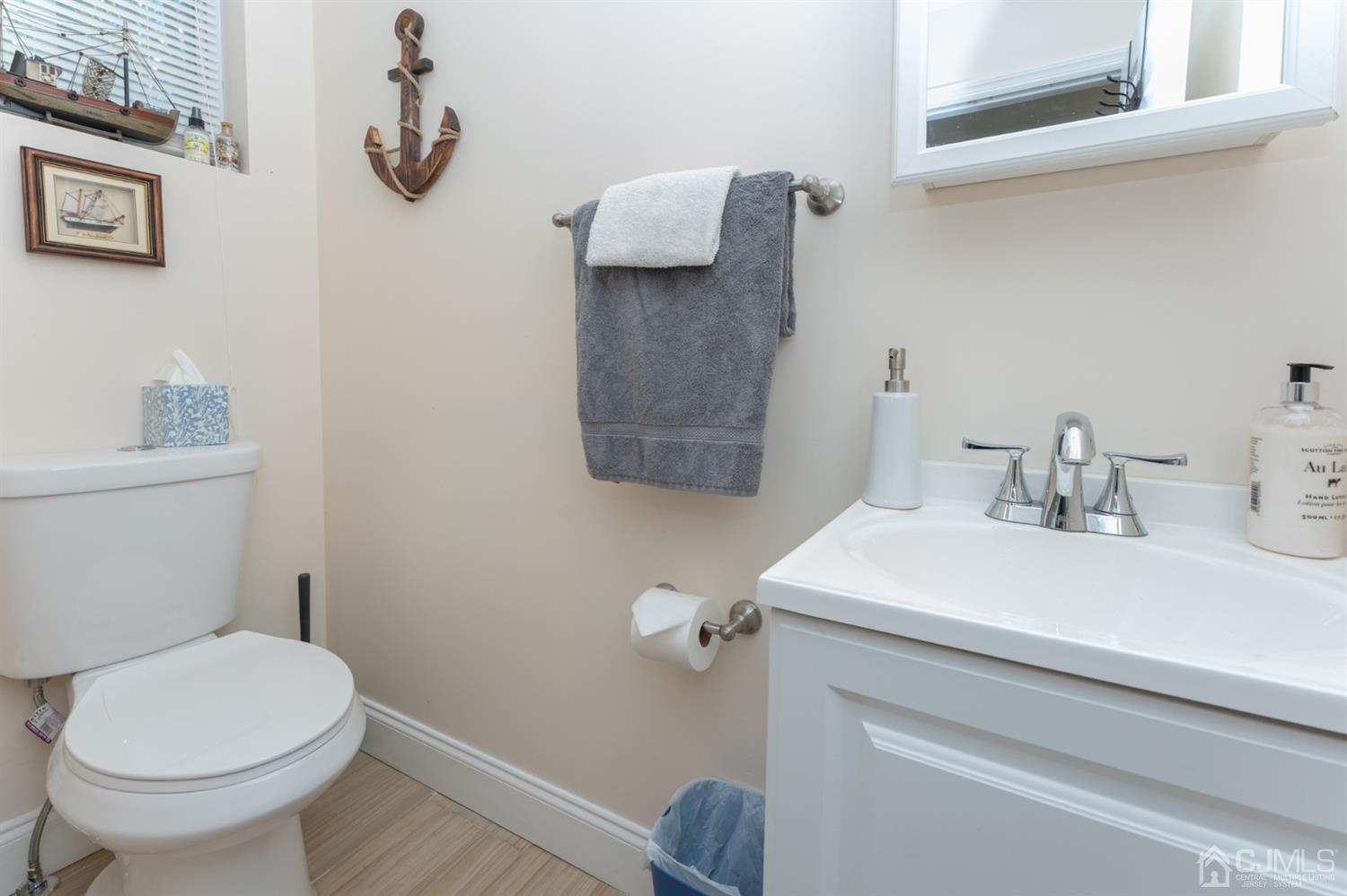 109 Stone Road Union Beach, NJ 07735 - Photo 13 of 21 a bathroom with a sink a toilet and a mirror