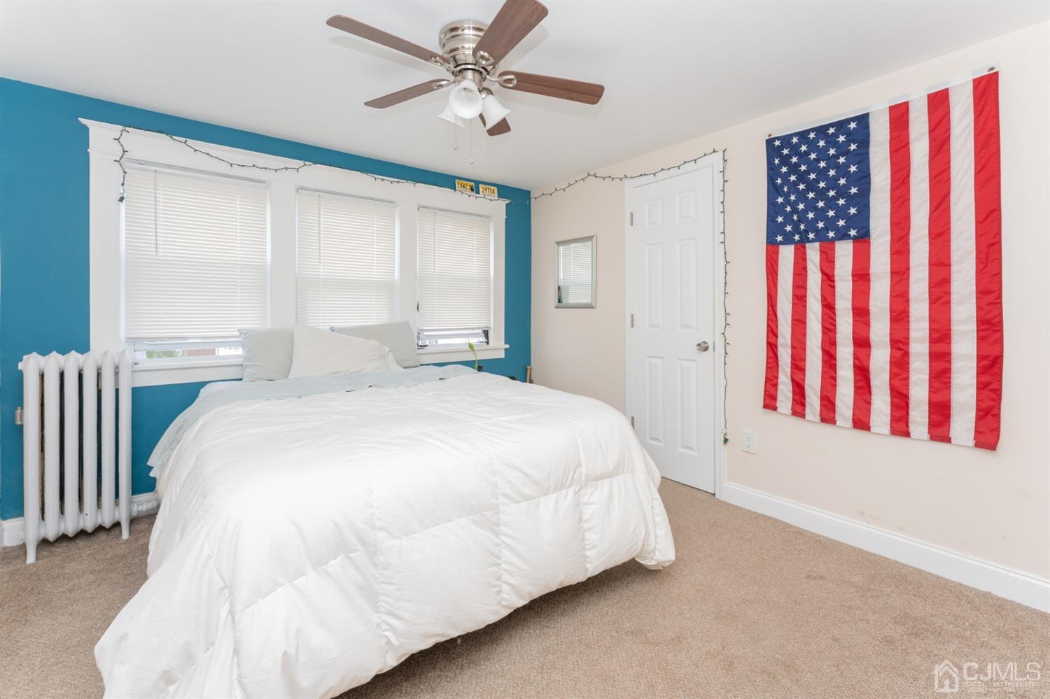 109 Stone Road Union Beach, NJ 07735 - Photo 14 of 21 a spacious bedroom with a bed and a chandelier