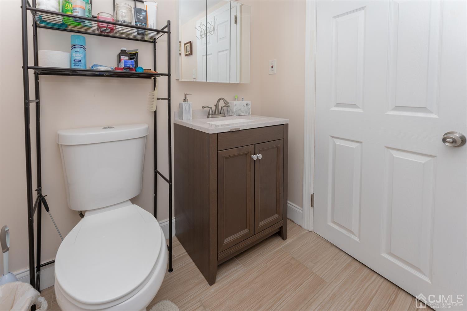 109 Stone Road Union Beach, NJ 07735 - Photo 18 of 21 a bathroom with a toilet sink and mirror