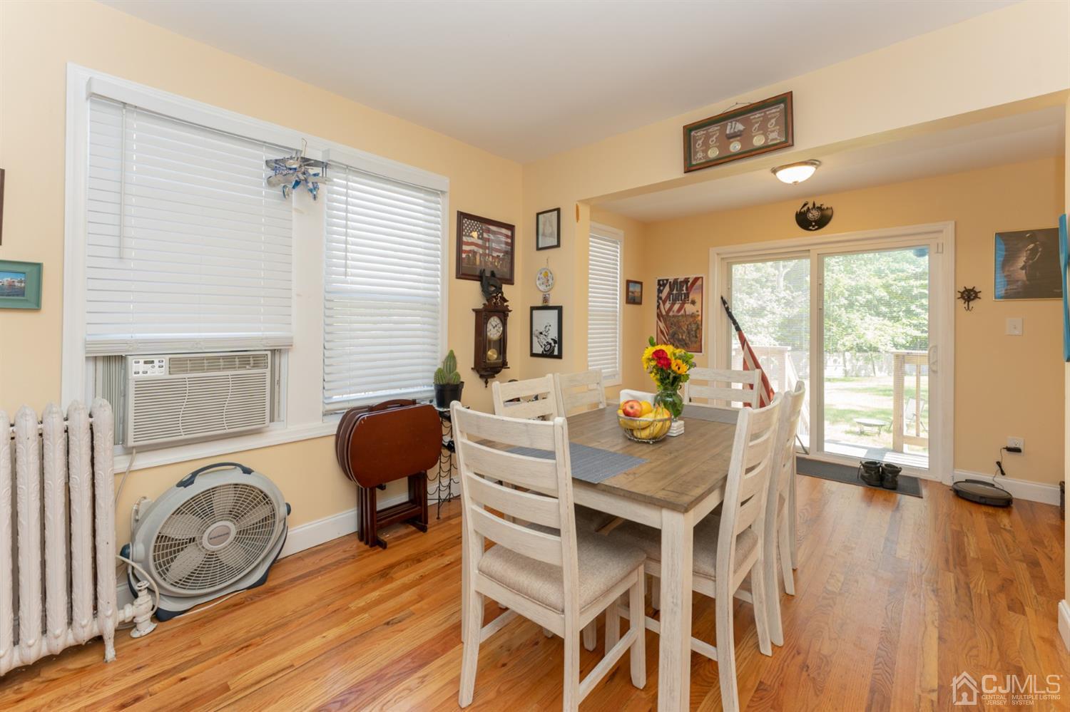 109 Stone Road Union Beach, NJ 07735 - Photo 7 of 21 a view of a dining room with furniture and wooden floor
