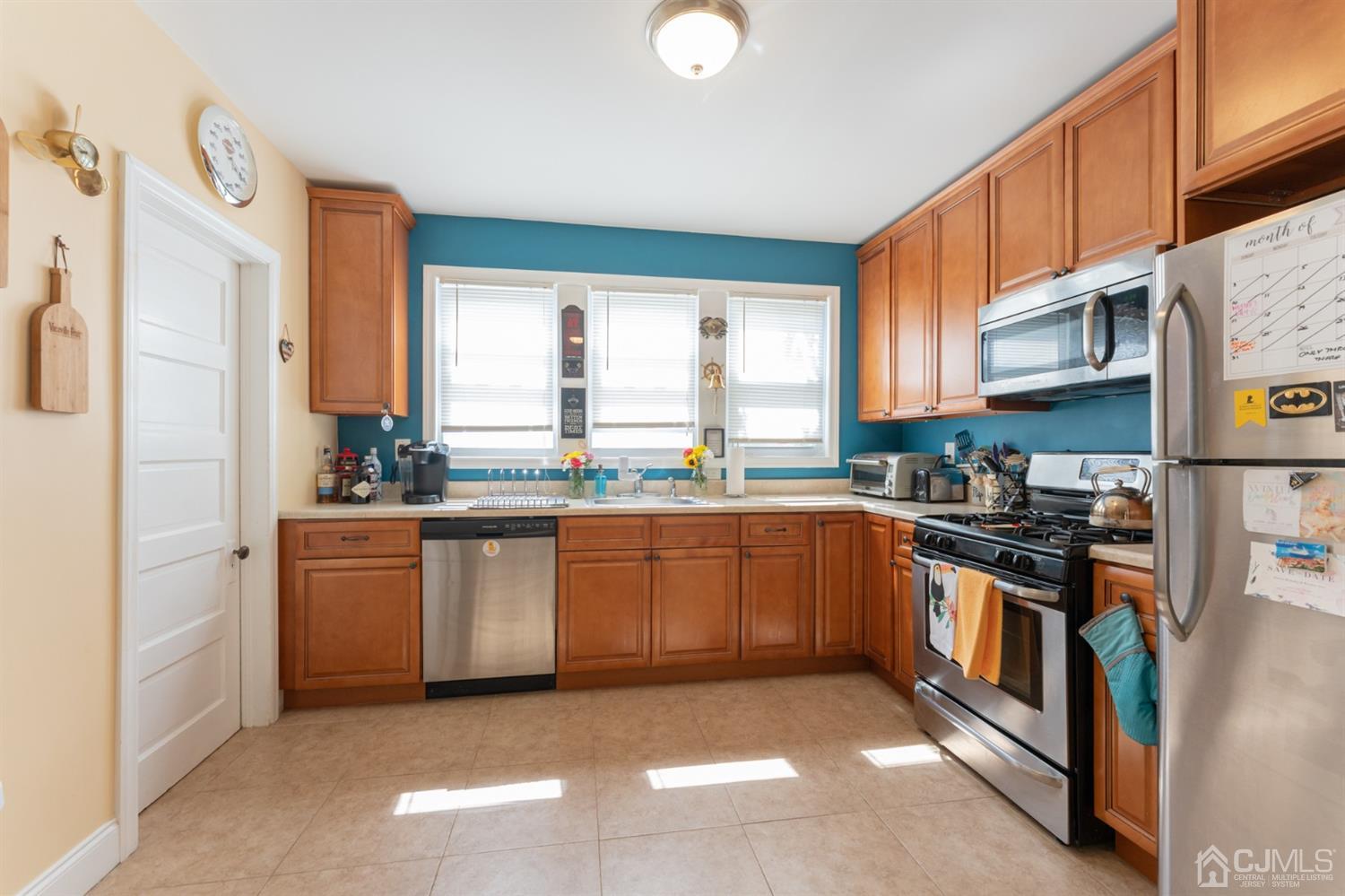 109 Stone Road Union Beach, NJ 07735 - Photo 8 of 21 a kitchen with stainless steel appliances granite countertop a stove a sink and a refrigerator