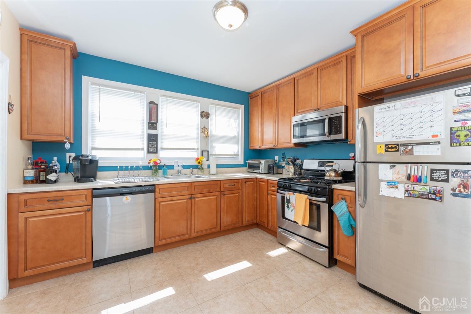 109 Stone Road Union Beach, NJ 07735 - Photo 9 of 21 a kitchen with stainless steel appliances granite countertop a stove sink and cabinets