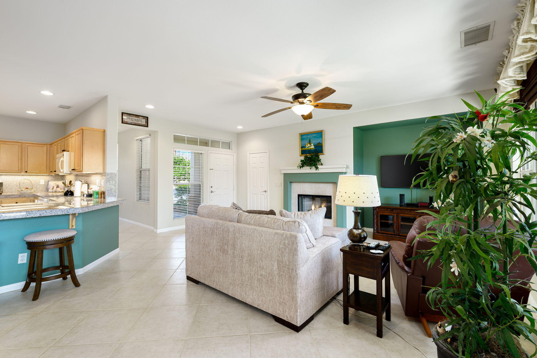60246 Sweetshade Lane La Quinta, CA 92253 - Photo 13 of 76 a living room with furniture a fireplace and a potted plant