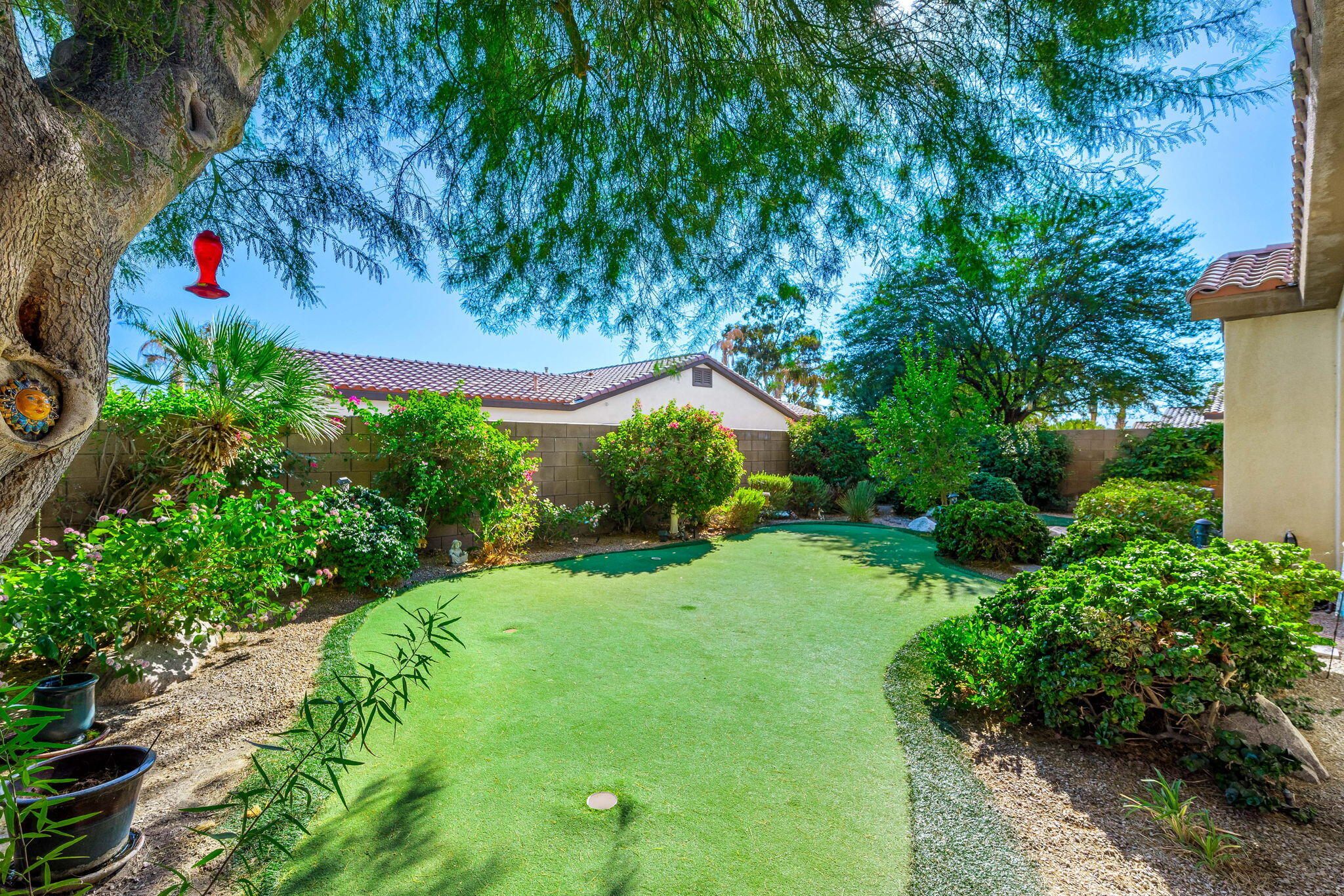 60246 Sweetshade Lane La Quinta, CA 92253 - Photo 30 of 76 a backyard of a house with lots of green space