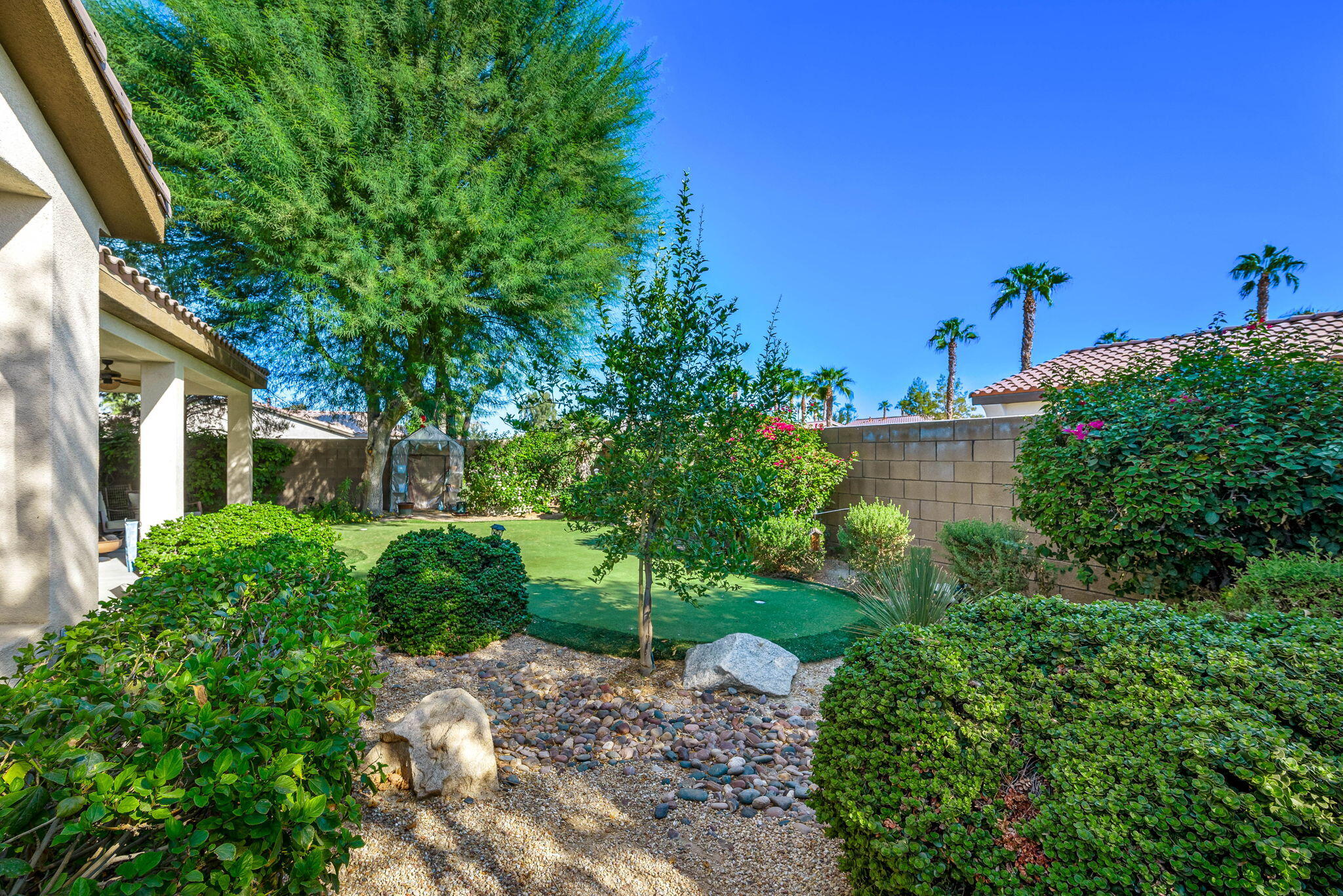 60246 Sweetshade Lane La Quinta, CA 92253 - Photo 33 of 76 a view of a garden with a building in the background