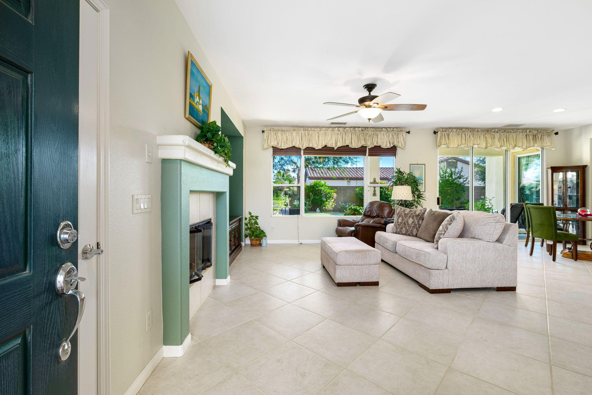 60246 Sweetshade Lane La Quinta, CA 92253 - Photo 7 of 76 a living room with furniture fireplace and large windows