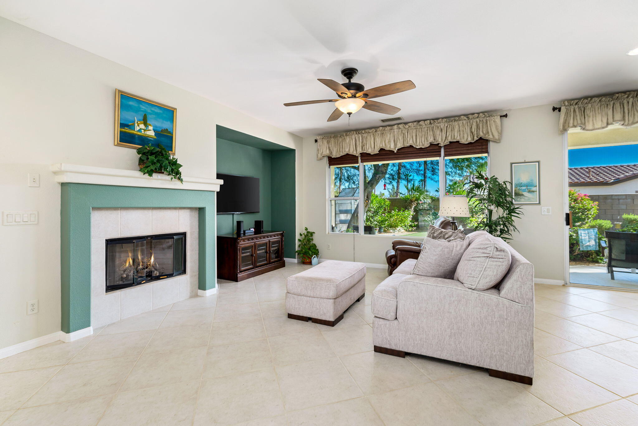 60246 Sweetshade Lane La Quinta, CA 92253 - Photo 10 of 76 a living room with furniture a fireplace and a large window