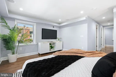 a bedroom with a bed and a flat screen tv