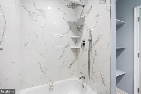 a bathroom with a bathtub and shower