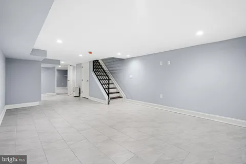 an empty room with white walls and stairs