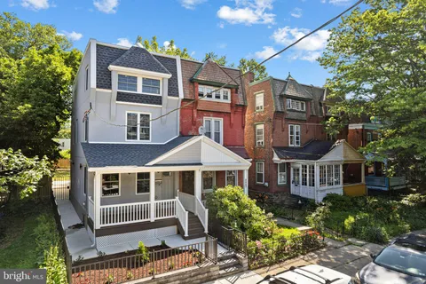 a front view of a residential apartment building with a yard