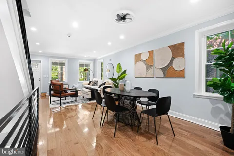 a view of a dining room with furniture window and wooden floor