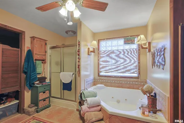 a bathroom with a bathtub a toilet and a shower