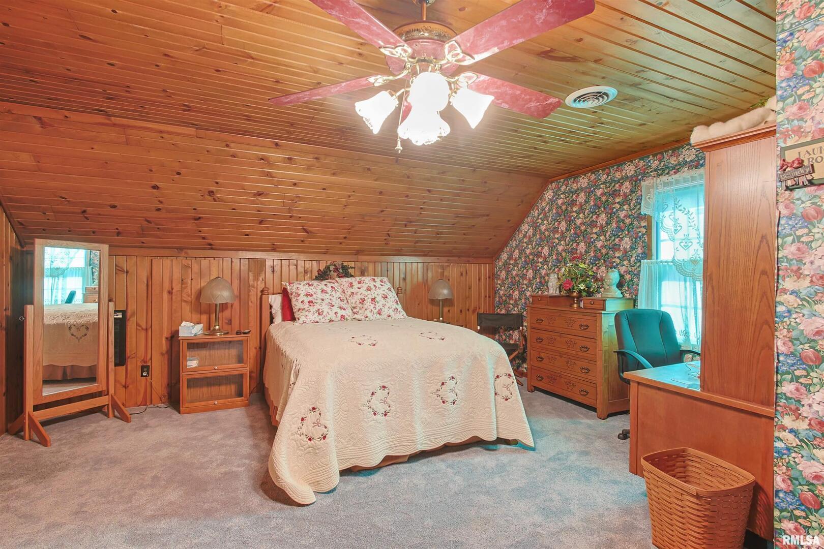 11939 Cochran Road Marion, IL 62959 - Photo 15 of 38 a bedroom with a bed and a chandelier