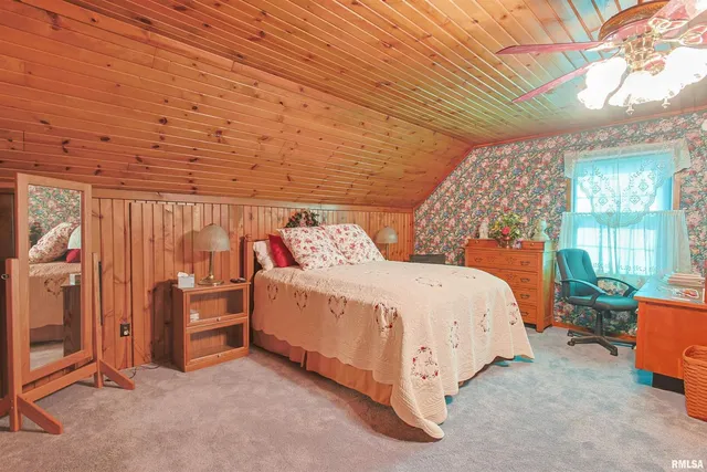 a bed room with a bed and a chair