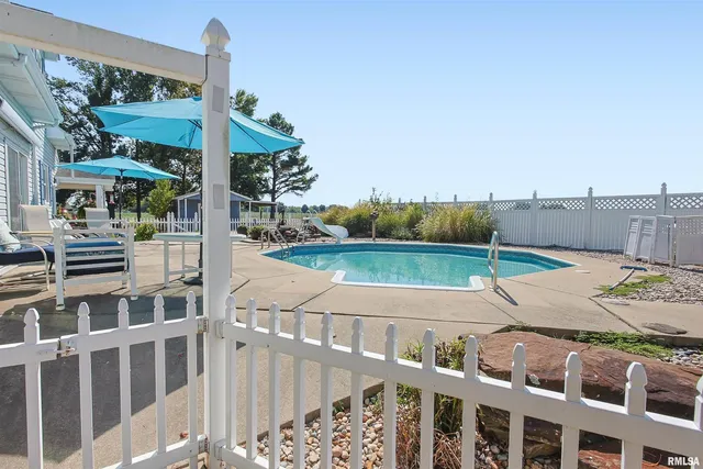 a view of a swimming pool with lounge chairs