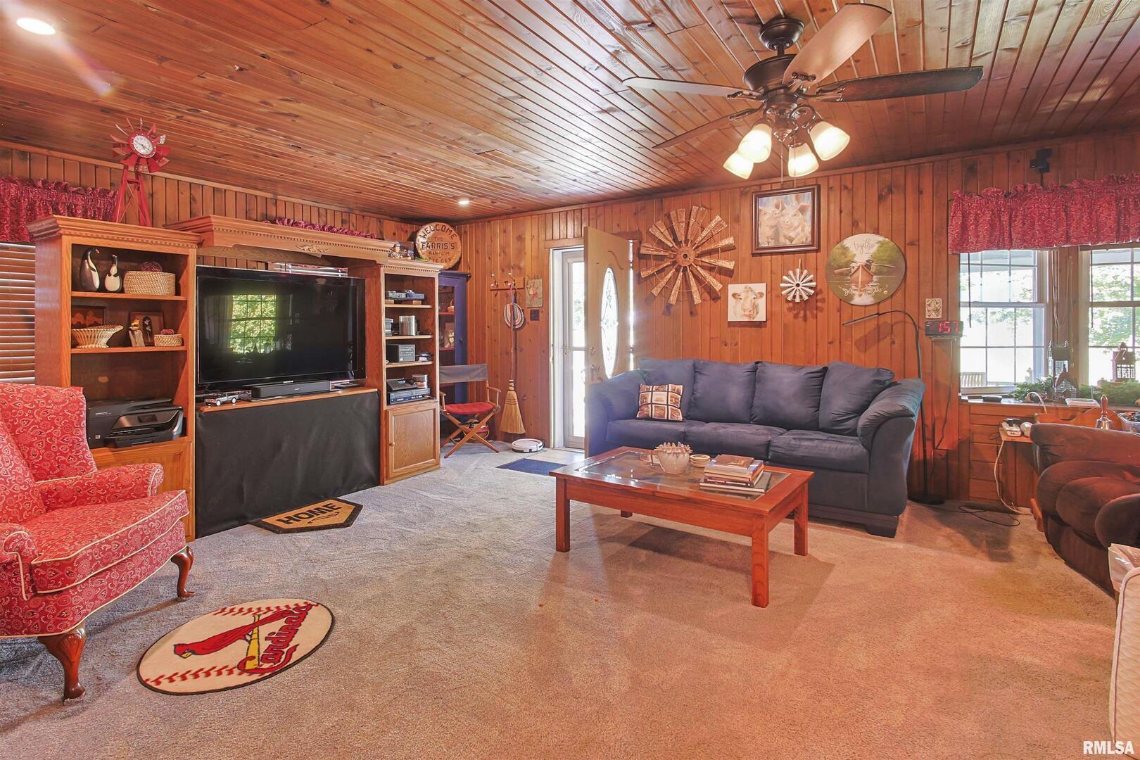 11939 Cochran Road Marion, IL 62959 - Photo 10 of 38 a living room with furniture a flat screen tv and a table