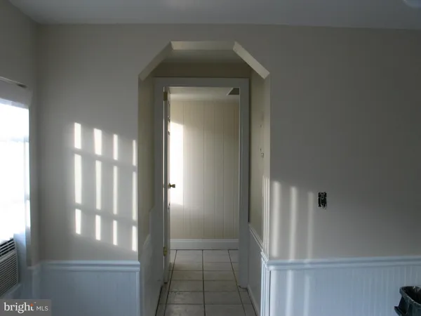a view of a hallway with windows and cabinet