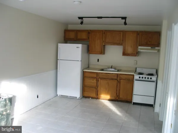 a utility room with cabinets washer and dryer