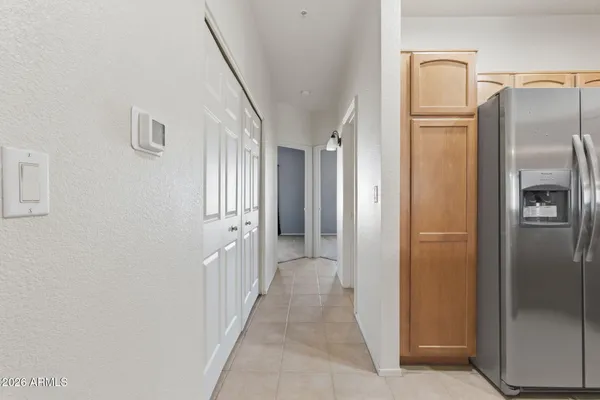 a view of a hallway with wooden cabinets