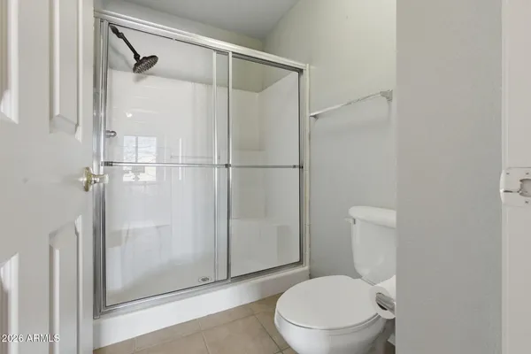 a white toilet sitting next to a bathroom sink