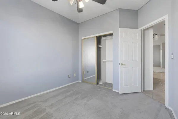 an empty room with a ceiling fan