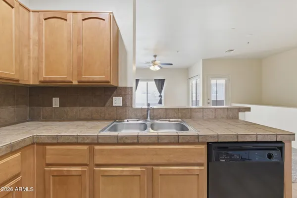 a kitchen with granite countertop a sink and white cabinets