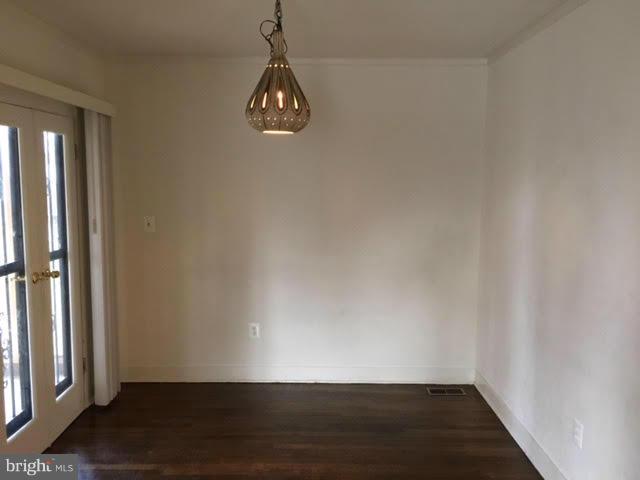 9904 Colesville Road Silver Spring, MD 20901 - Photo 11 of 23 an empty room with wooden floor and windows