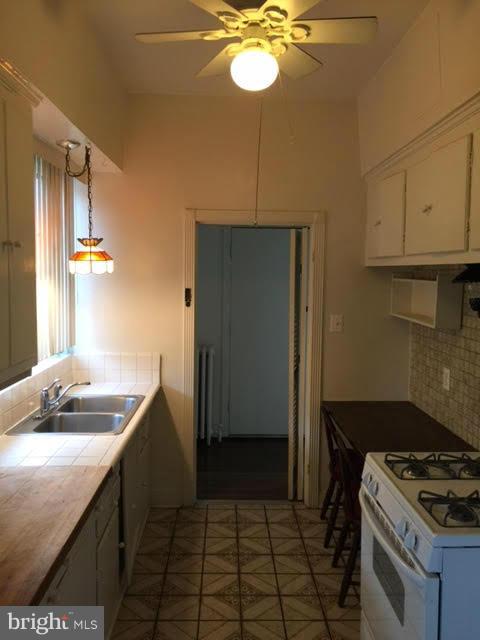 9904 Colesville Road Silver Spring, MD 20901 - Photo 12 of 23 a kitchen with stainless steel appliances granite countertop a sink a stove and a refrigerator