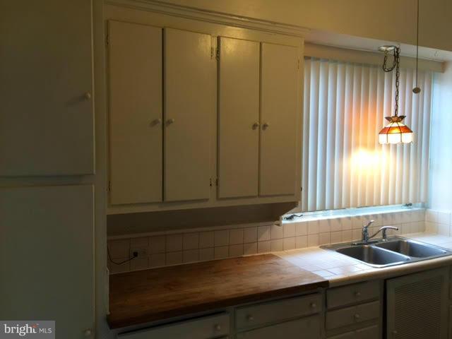 9904 Colesville Road Silver Spring, MD 20901 - Photo 14 of 23 a bathroom with a sink and a mirror