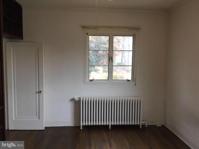 9904 Colesville Road Silver Spring, MD 20901 - Photo 18 of 23 an empty room with wooden floor and windows