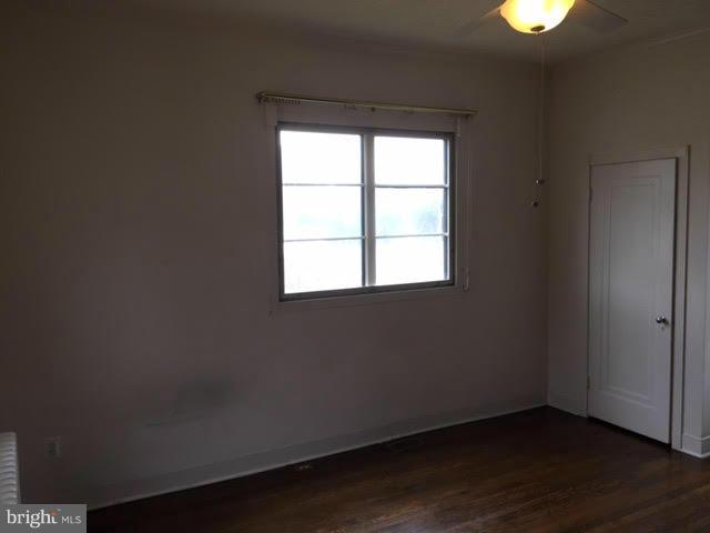 9904 Colesville Road Silver Spring, MD 20901 - Photo 22 of 23 an empty room with wooden floor and windows