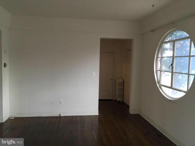 9904 Colesville Road Silver Spring, MD 20901 - Photo 9 of 23 an empty room with wooden floor and windows