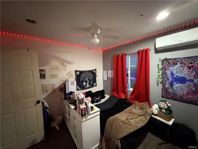 a bedroom with furniture and a flat screen tv