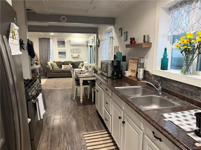a kitchen with granite countertop a sink appliances and cabinets