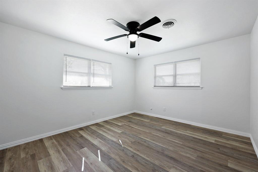 913 North Main Street Springtown, TX 76082 - Photo 12 of 25 a view of empty room with wooden floor and fan