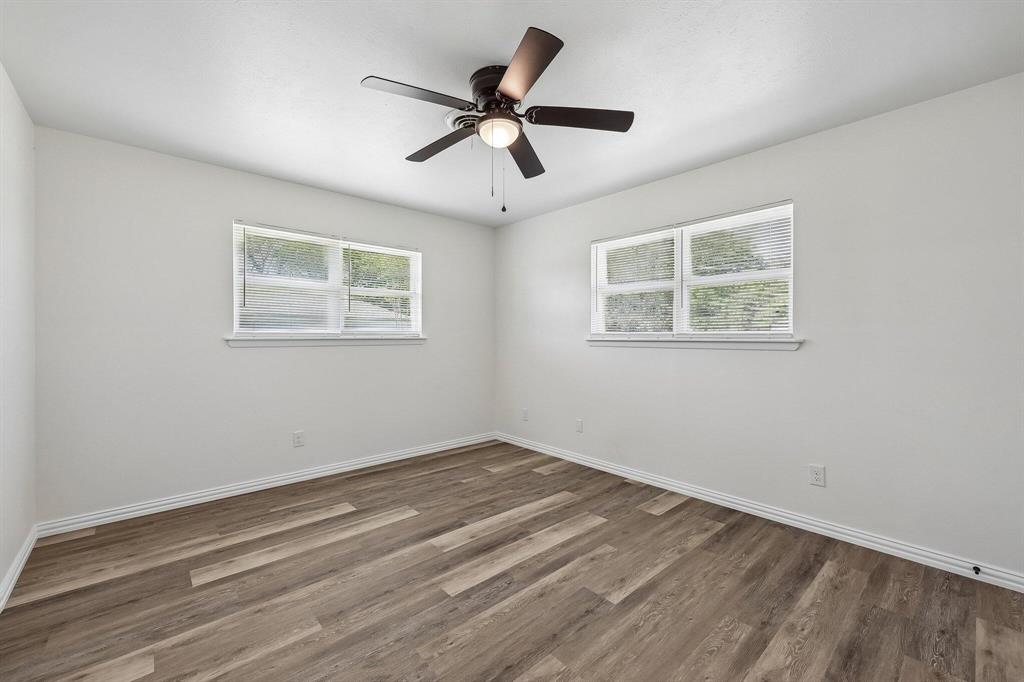 913 North Main Street Springtown, TX 76082 - Photo 15 of 25 a view of empty room with wooden floor and ceiling fan