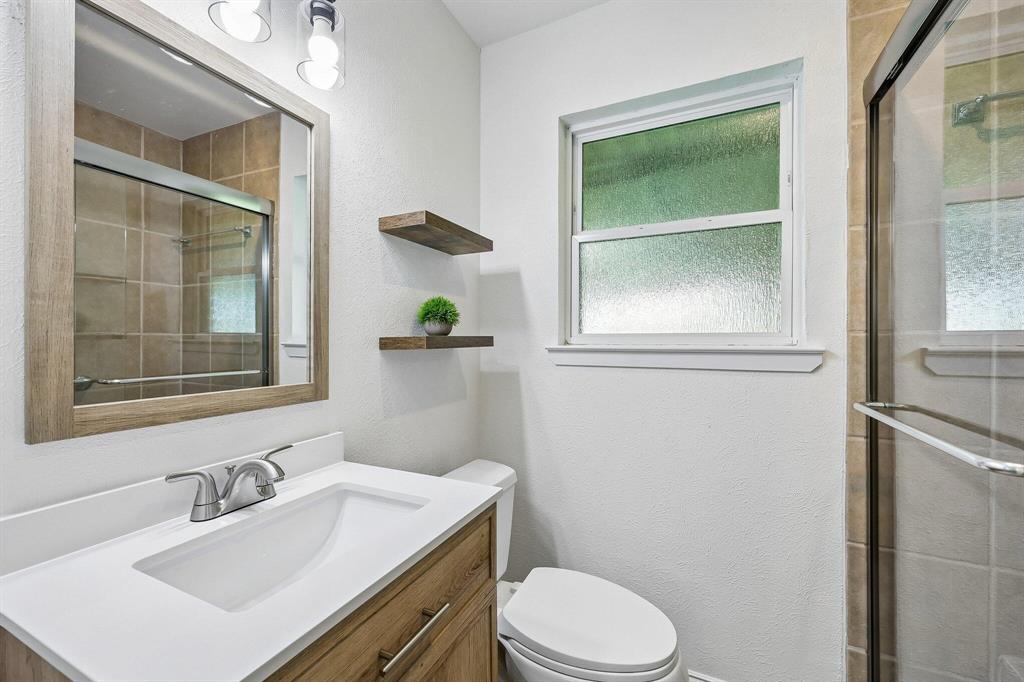 913 North Main Street Springtown, TX 76082 - Photo 18 of 25 a bathroom with a sink vanity mirror and toilet