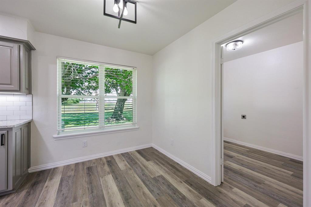 913 North Main Street Springtown, TX 76082 - Photo 19 of 25 a view of an empty room with wooden floor and a window