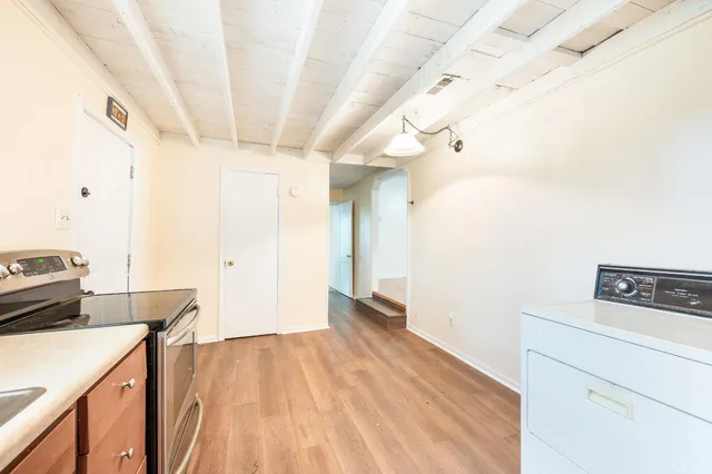a view of a room with wooden floor