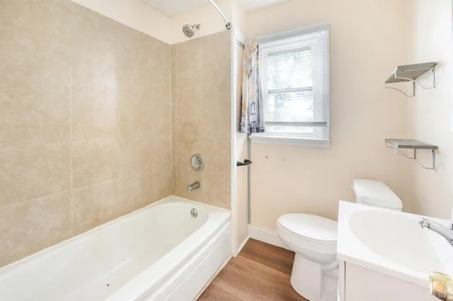 a bathroom with a sink toilet and a mirror