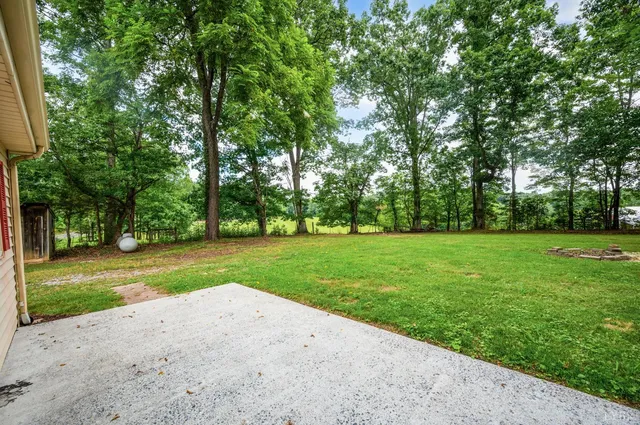a view of a house with a backyard