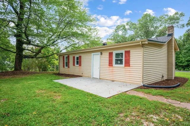 a view of a house with yard and basketball ground