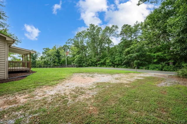 a backyard of a house with yard and trampoline