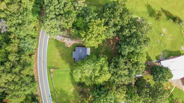 a aerial view of a house with a yard