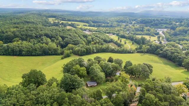 a backyard of a house with a yard and outdoor seating