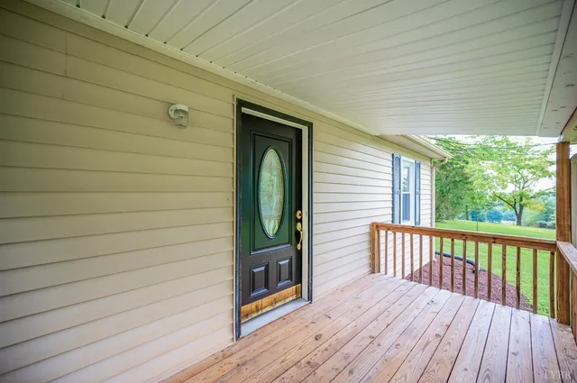 a porch with wooden floor and furniture