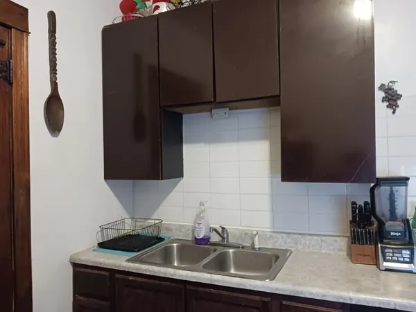 a kitchen with a sink and cabinets